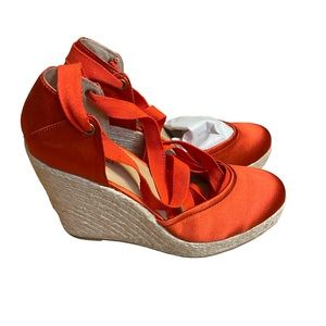 Cute burnt orange espadrilles with ribbon laces.